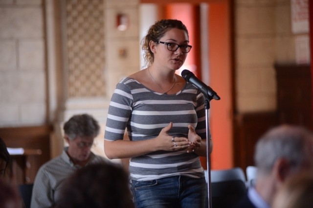 A Columbia University student asks the panel a question during the question and answer session.