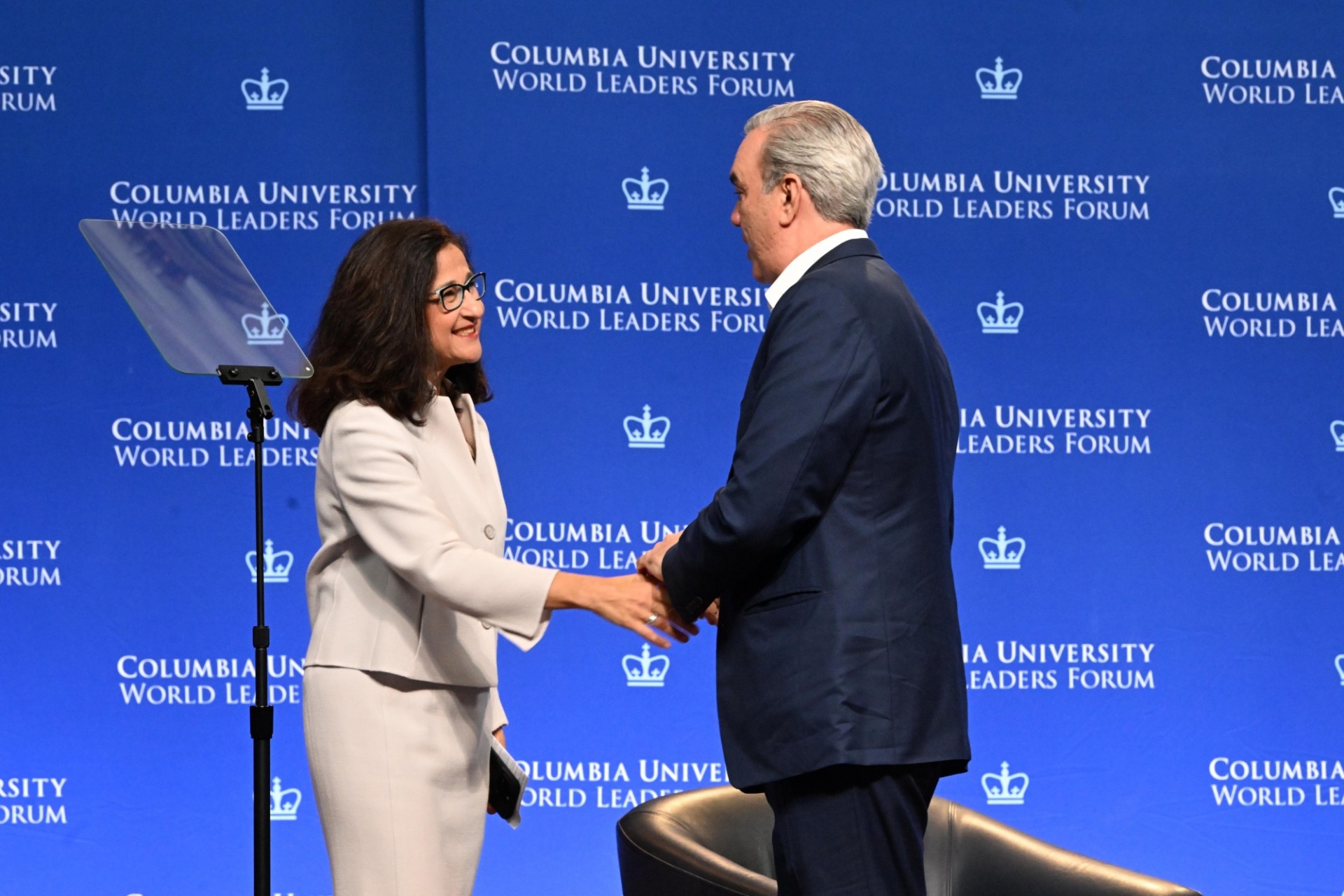 Columbia University President Minouche Shafik (left) shakes hands with President Luis Abinader Corona of the Dominican Republic (right) during the World Leaders Forum