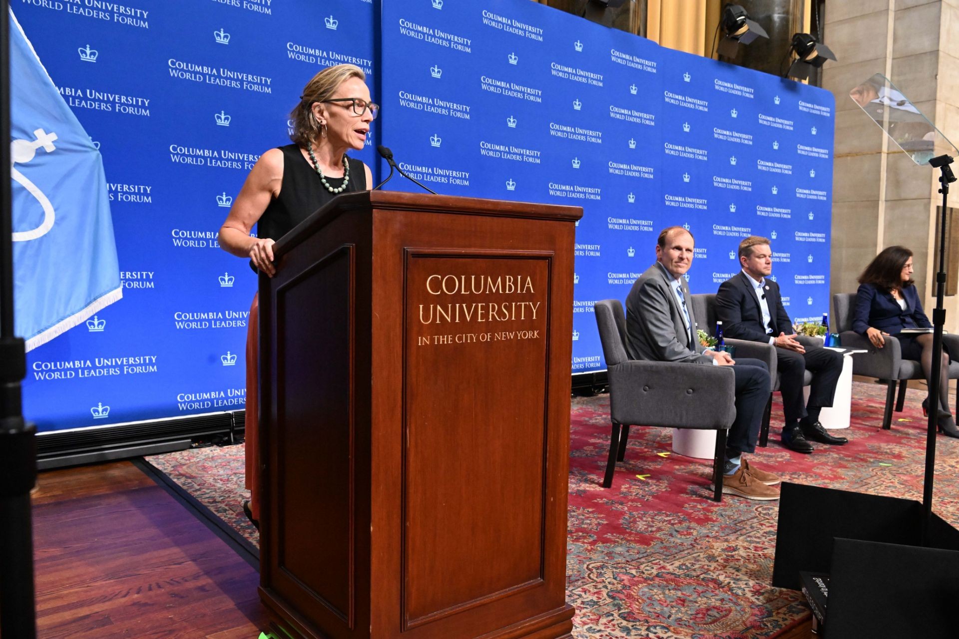 Program director of M.S. Nonprofit Management at the School of Professional Studies, Sarah Holloway speaking at the podium during the World Leaders Forum