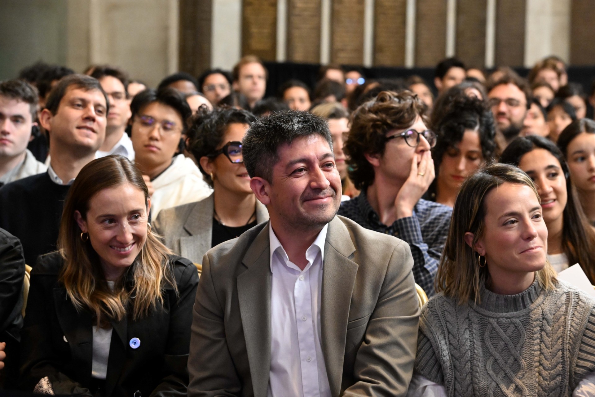 An audience including Columbia University students, scholars, and faculty listening to the discussion.