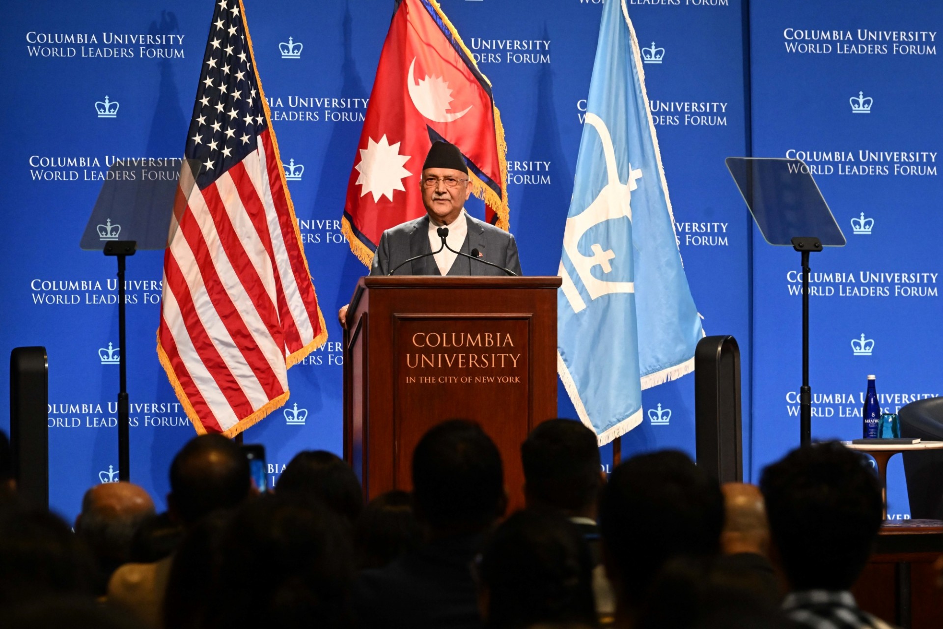 Prime Minister of Nepal speaking at the podium.