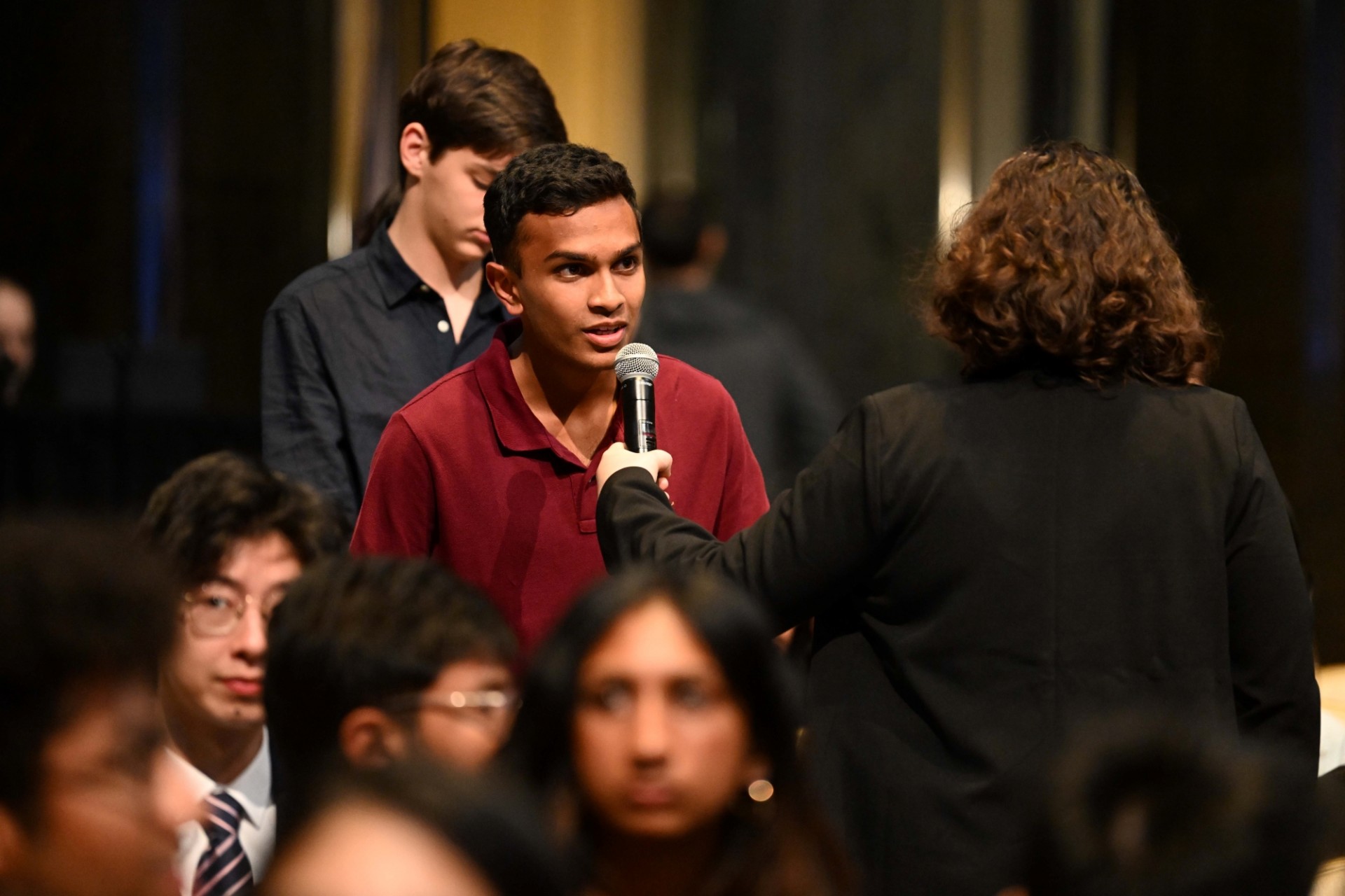 Student asking questions to the Prime Minister of Nepal.