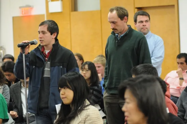 Members of the audience participate in the question and answer portion of the address.