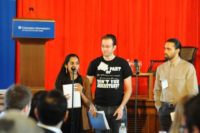 Student participants report to the larger group on the issues discussed at their tables.