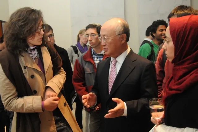 Director General Amano interacts with guest at the post-event reception.