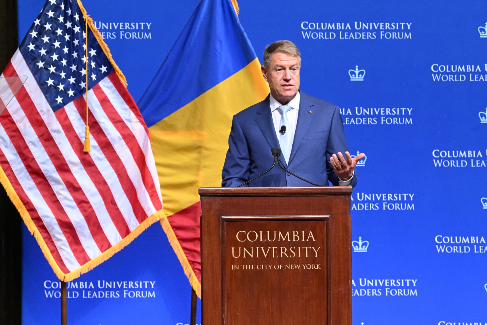 President Klaus Werner Iohannis of Romania speaking at the podium during the World Leaders Forum