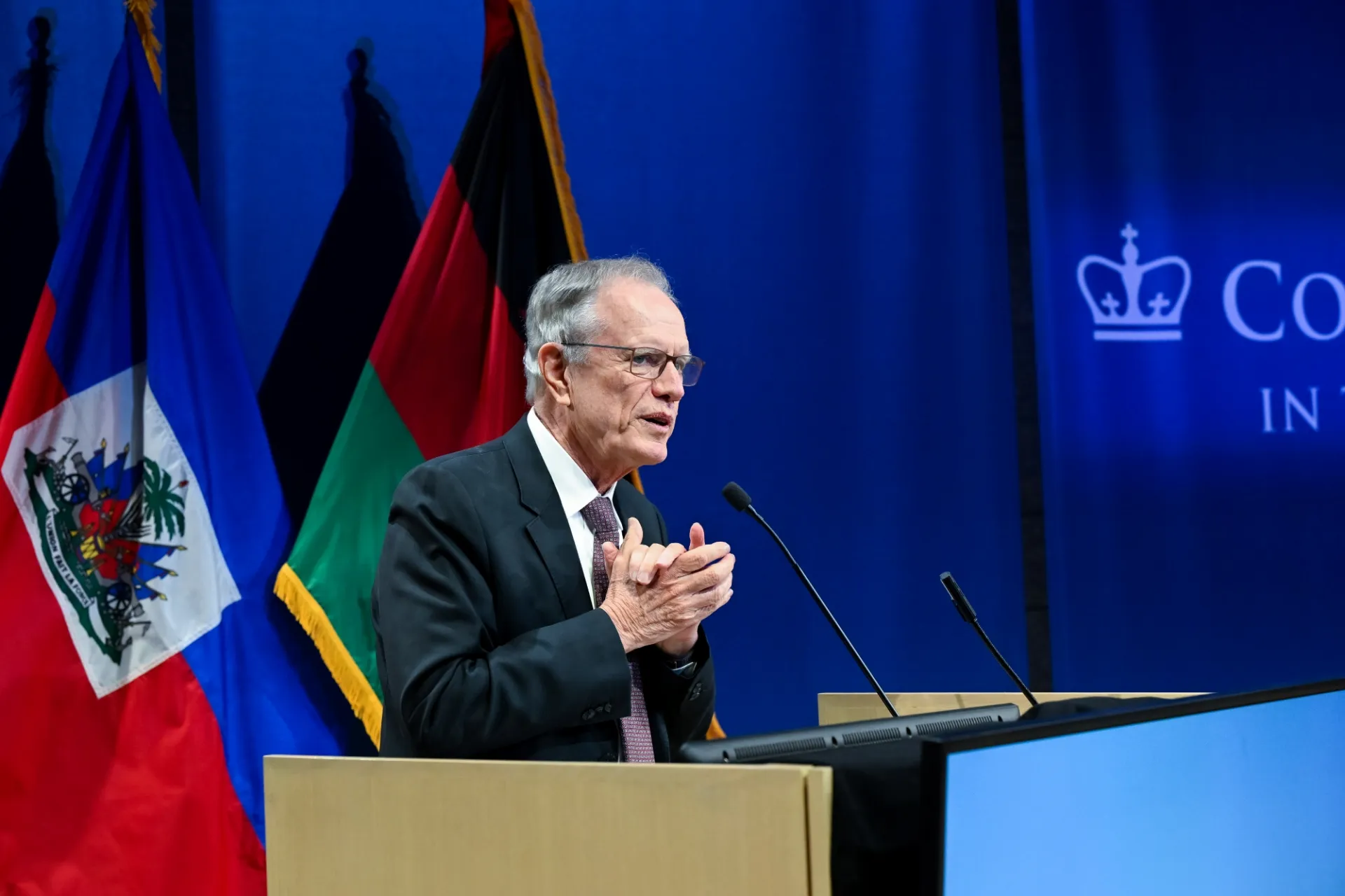 Moderator Dr. Thomas J. Trebat speaking at the podium.