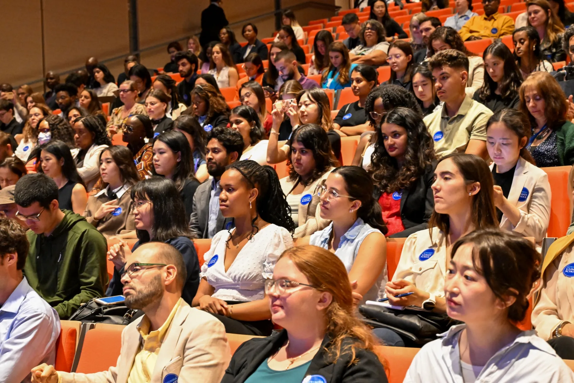 An audience including Columbia University students, scholars, and faculty listening to the discussion.