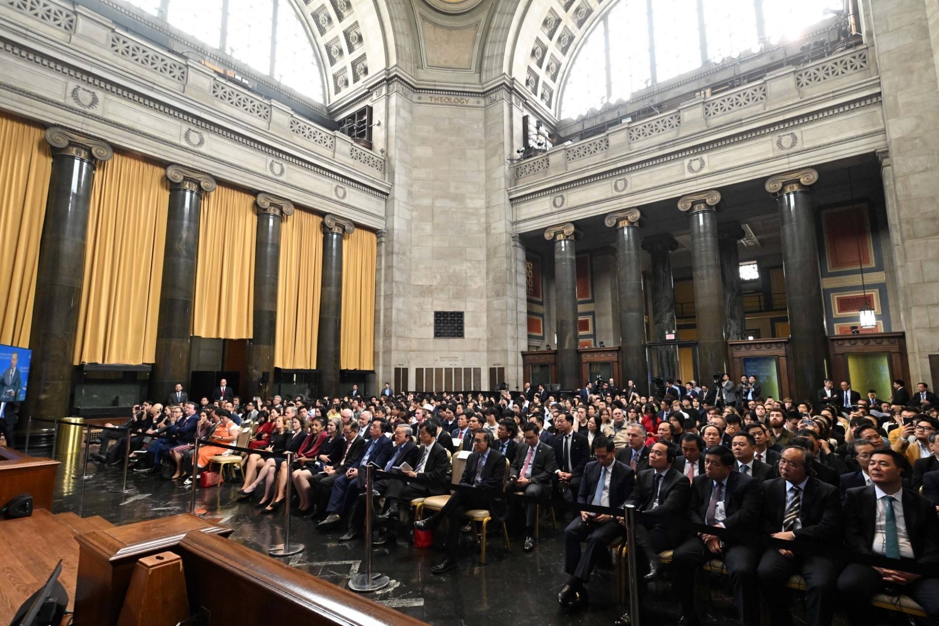 An audience including Columbia University students, scholars, and faculty listening to the discussion.