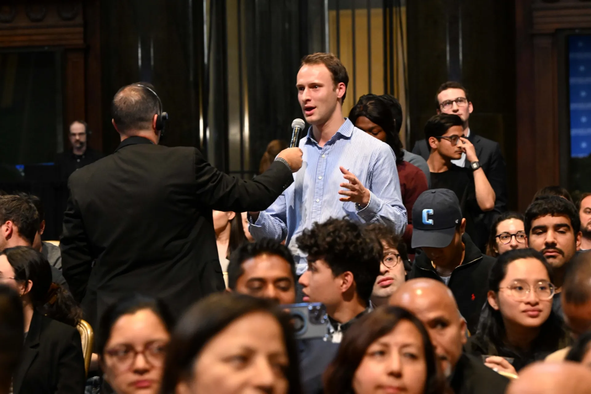 Student asking questions to the Prime Minister of Nepal.