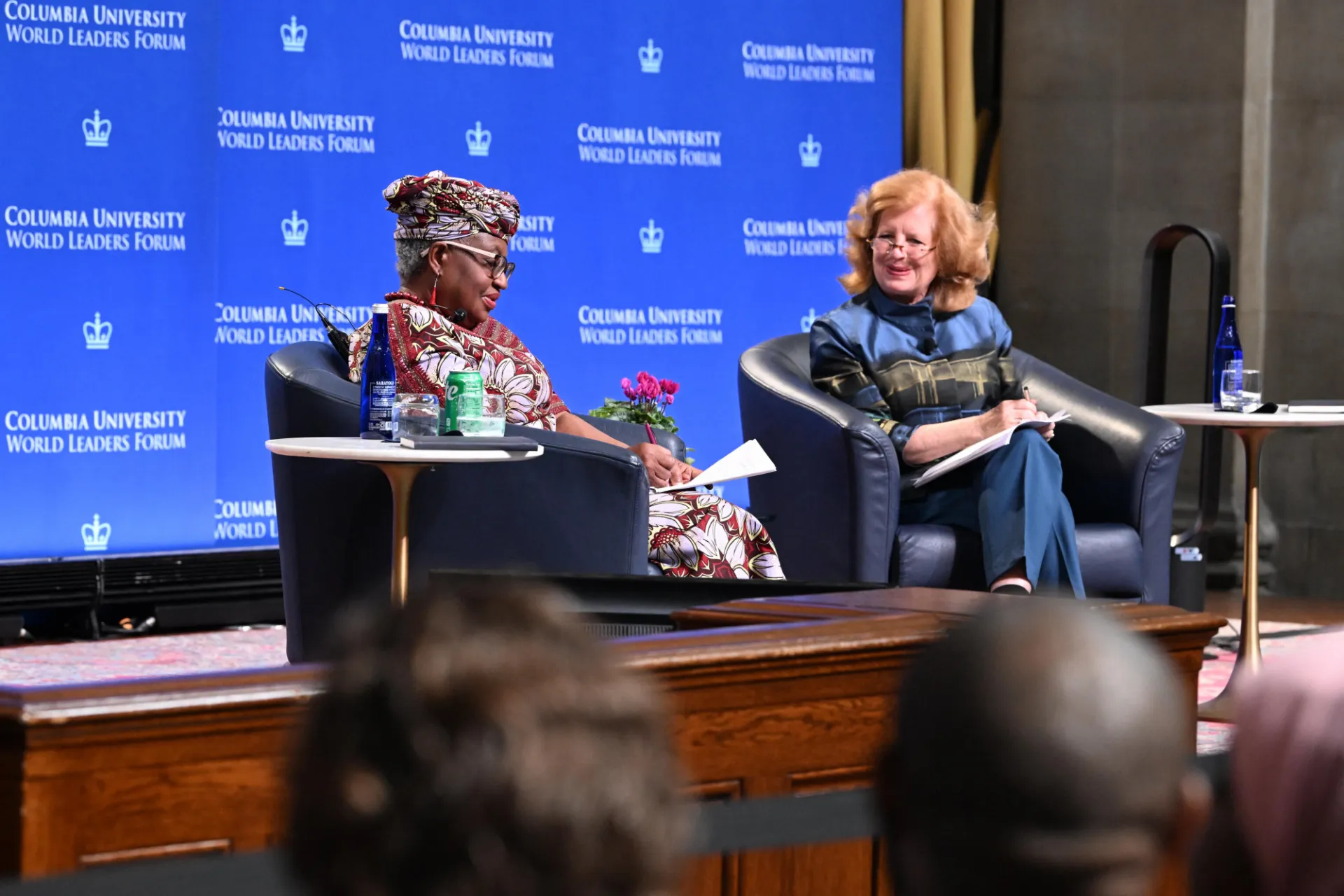 Director-General Ngozi Okonjo-Iweala answering student questions on stage with moderator Professor Merit Janow.