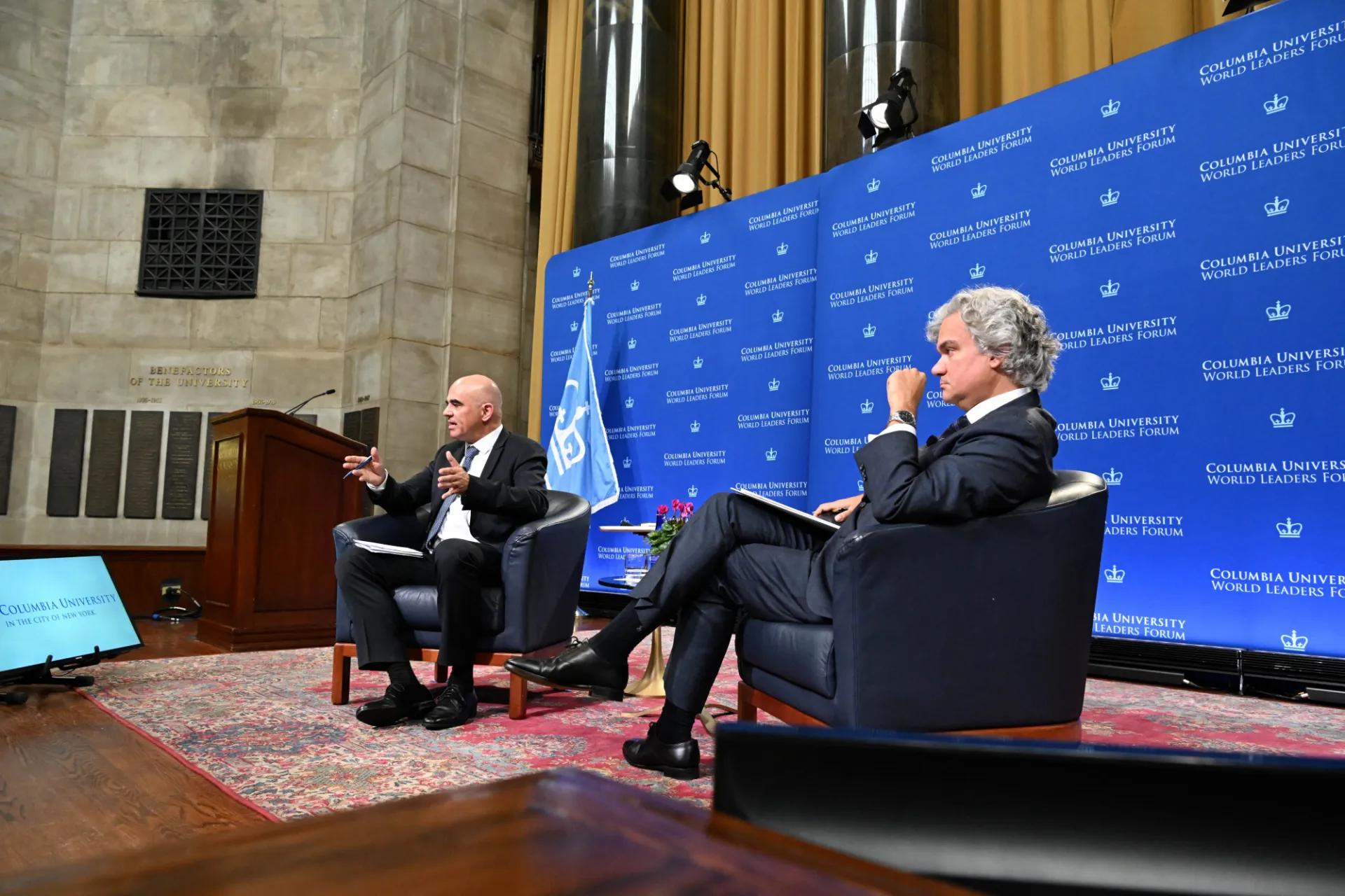Secretary General Alain Berset answering student questions while seated on stage with moderator.