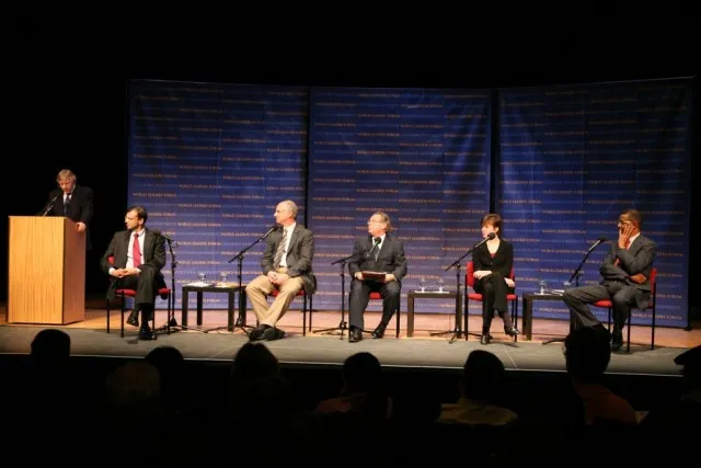 Panelists listen as President Lee C. Bollinger welcomes the audience to the program, which took place in Columbia’s own Miller Theatre.